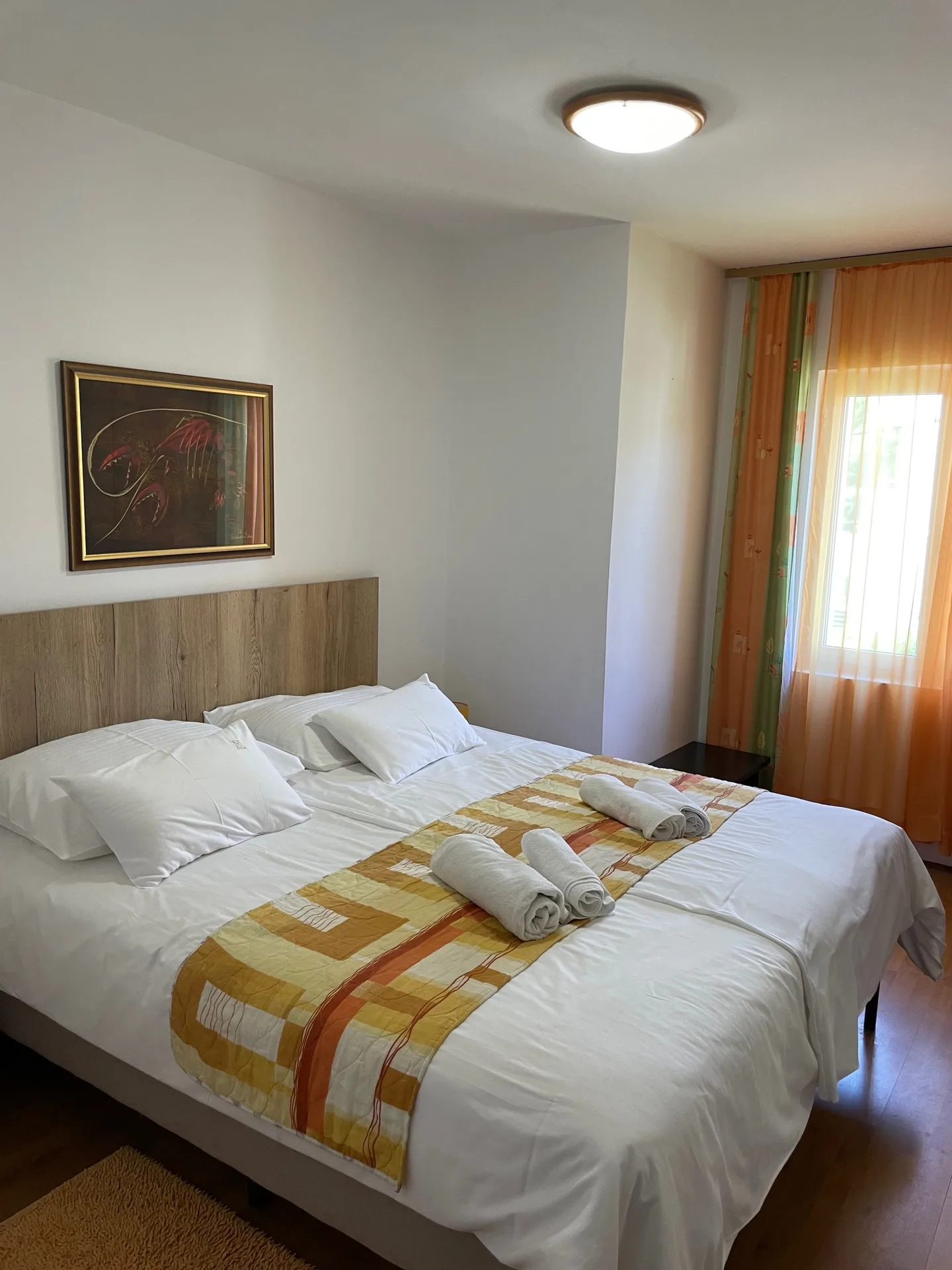 Bedroom with a double bed and folded towels.