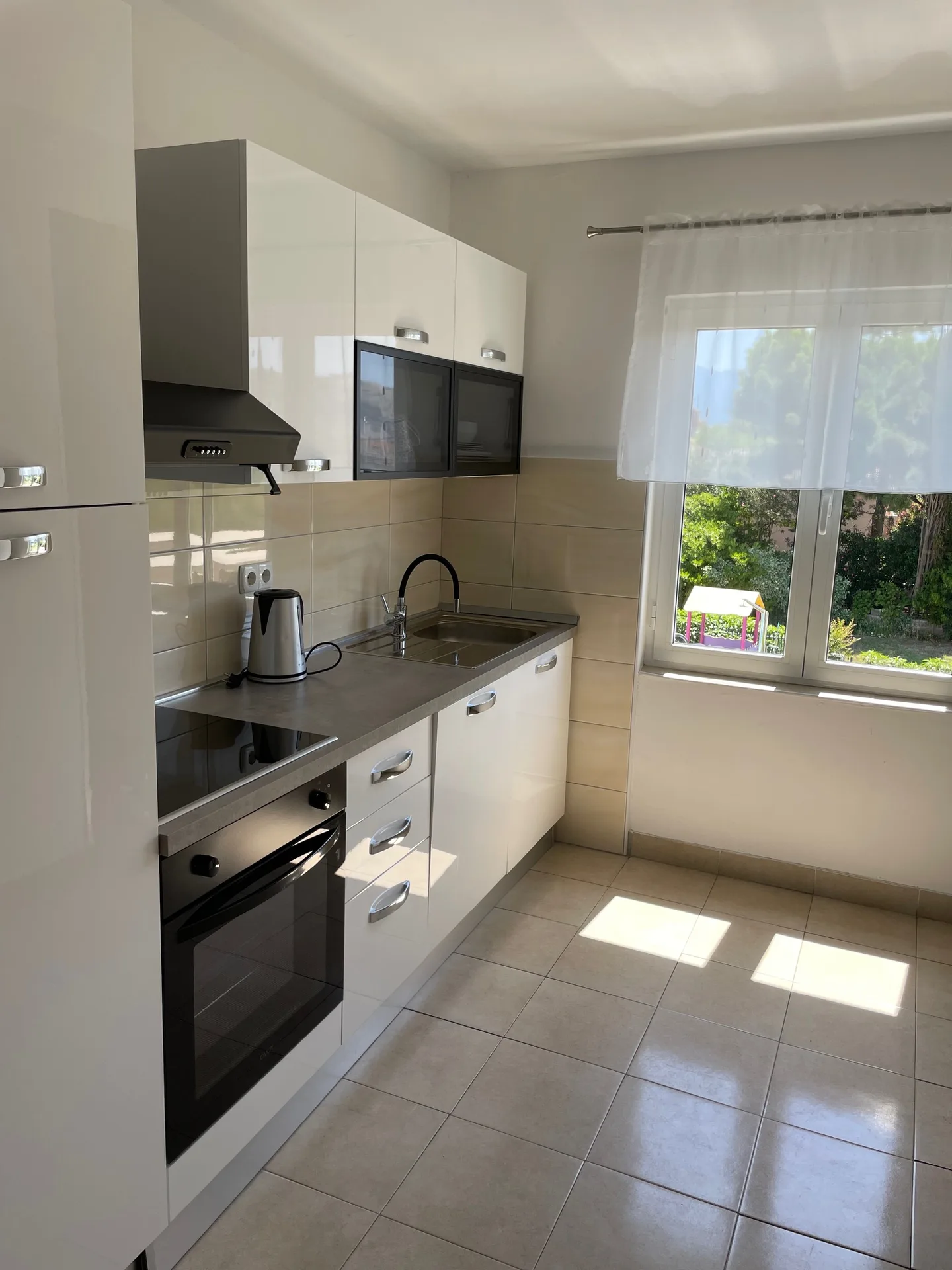 Kitchen countertop with sink and stove.
