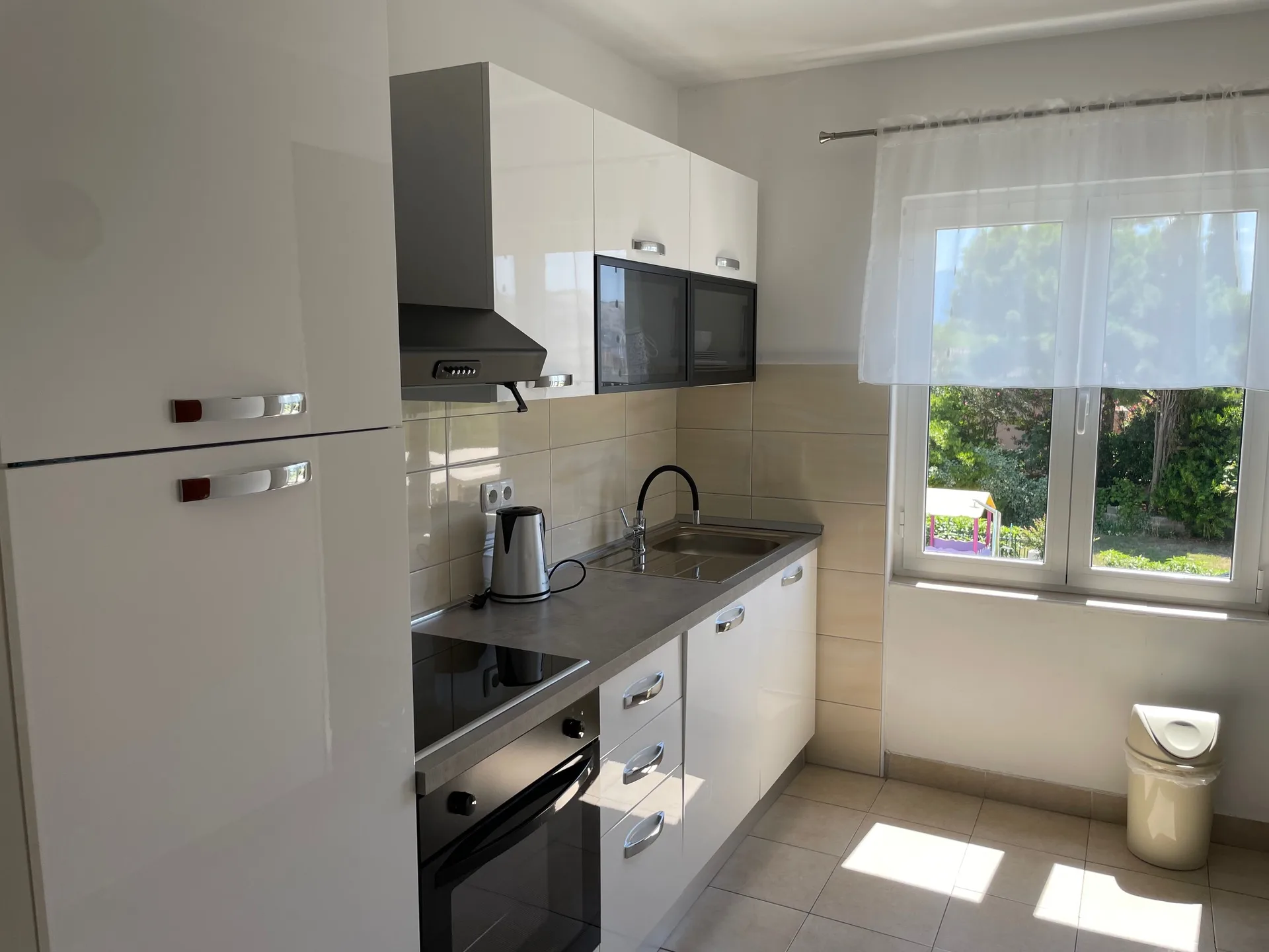 Fully equipped kitchen with a window view.